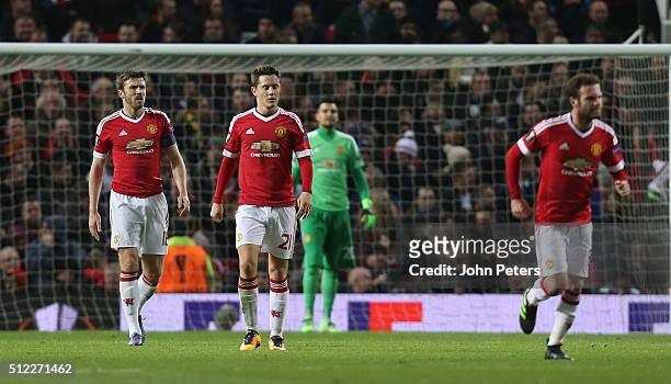 Michael Carrick, Ander Herrera and Juan Mata of Manchester United react to Pione Sisto of FC Midtjylland scoring their first goal during the UEFA...