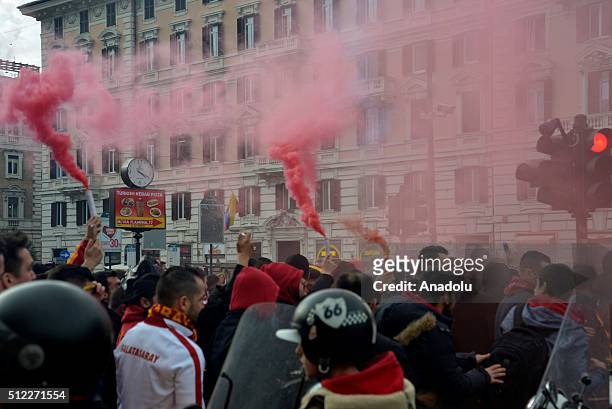 Galatasaray fans hold torches as they march from Popolo Square to Villa Borghese Park to show their support prior to the UEFA Europa League, Round of...