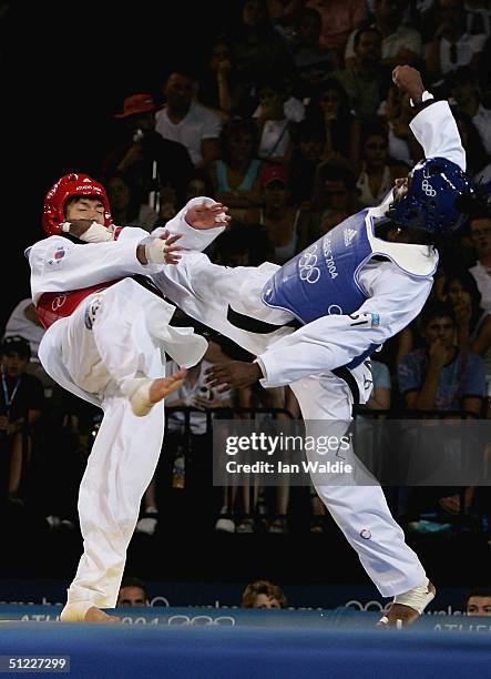 Myeong Seob Song of Korea gets kicked in the mouth by Diogo Silva of Brazil in the men's under 68 kg Taekwondo bronze medal match on August 27, 2004...