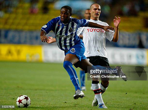 Benni McCarthy of FC Porto jumps a tackle from Ruben Baraja of Valencia, during the UEFA Super Cup match between FC Porto and Valencia at the Stade...