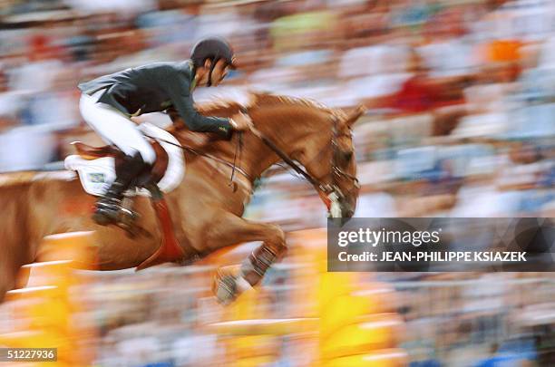 Brazilian Rodrigo Pessoa and his horse Baloubet du Rouet jump a fence during the individual jumping in the equestrian jumping competition at the...