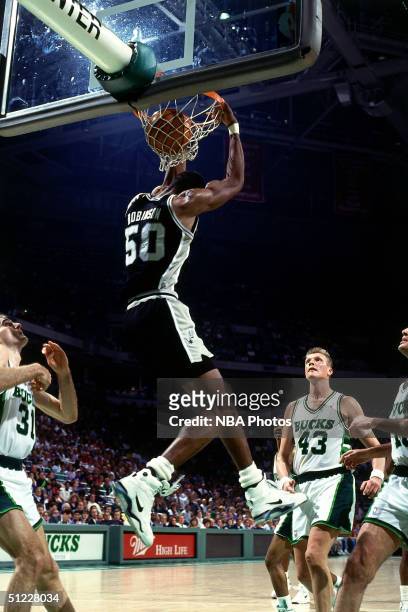 David Robinson of the San Antonio Spurs goes up for a dunk against the Milwaukee Bucks during an NBA game in 1990 at Bradley Center in Milwaukee,...