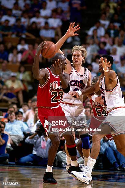 Craig Ehlo of the Cleveland Cavaliers plays defense against Michael Jordan of the Chicago Bulls during an NBA game in 1991 at Richfield Coliseum in...