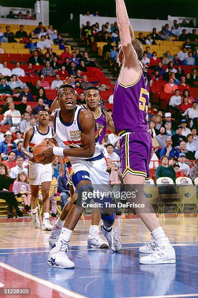 Dikembe Mutombo of the Denver Nuggets looks for an open shot in the post against the Utah Jazz during an NBA game in 1991 at the McNichols Sports...