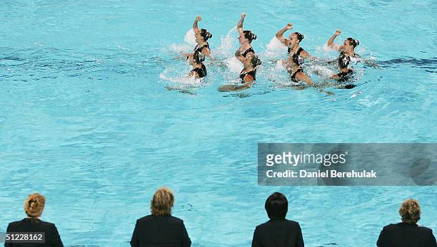 The judges watch as team Canada performs in the team free routine event on August 27, 2004 during the Athens 2004 Summer Olympic Games at the...