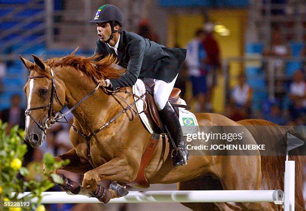 Brazilian jumping rider Rodrigo Pessoa wins silver on his horse "Baloubet Du Rouet" 27 August 2004 at the Markopoulo Olympic Equestrian Centre in...