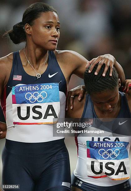 Marion Jones and Lauryn Williams of USA walk dejected after the women's 4 x 100 metre relay on August 27, 2004 during the Athens 2004 Summer Olympic...