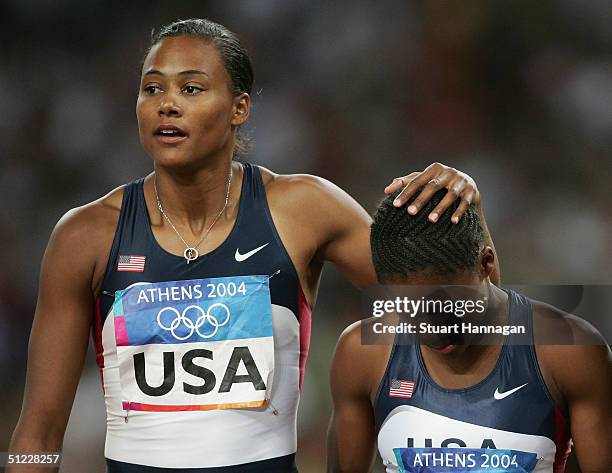 Marion Jones and Lauryn Williams of USA walk dejected after the women's 4 x 100 metre relay on August 27, 2004 during the Athens 2004 Summer Olympic...