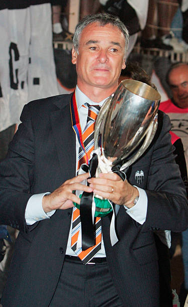 The Valencia manager, Claudio Ranieri, holds the UEFA Super Cup after his team defeated Porto in the UEFA Super Cup match at the Stade Louis II on...