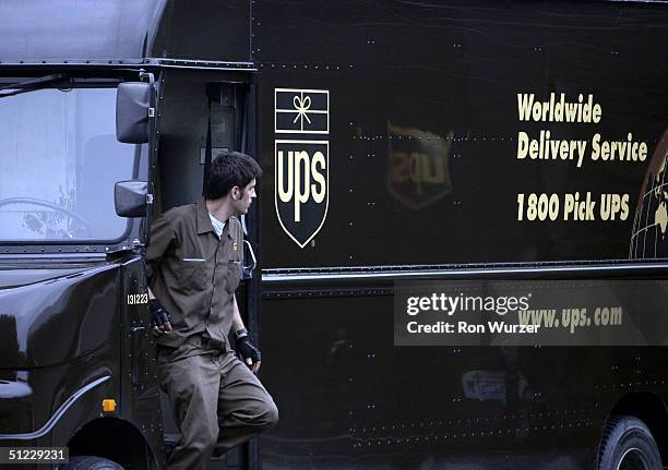 An United Parcel Service driver gets out of his truck at the end of his route, at the Seattle HUB on August 27, 2004 in Seattle, Washington. United...