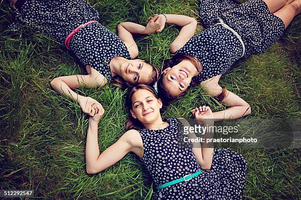 sisters - triplet stock pictures, royalty-free photos & images