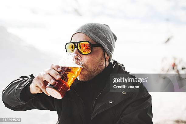 drinking a beer at after ski - beer helmet stock pictures, royalty-free photos & images