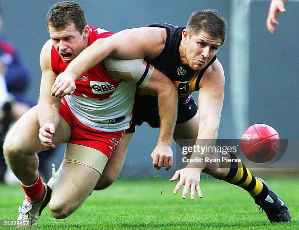 Bill Nicholls for the Tigers competes for the ball against Paul Williams for the Swans during the round twenty two AFL match between The Richmond...