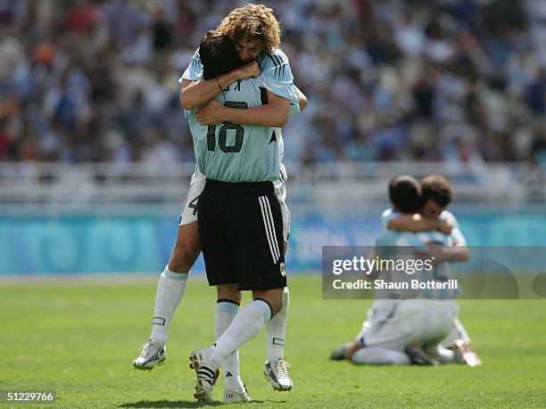 Fabricio Coloccini and German Lux of Argentina hug and celebrate after Argentina beat Paraguay 1-0 to claim the men's football gold medal in the...