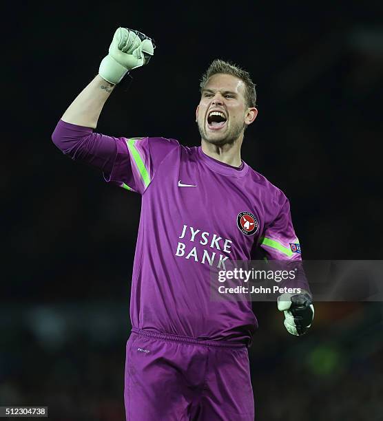 Mikkel Andersen of FC Midtjylland celebrates Pione Sisto scoring their first goal during the UEFA Europa League match between Manchester United and...