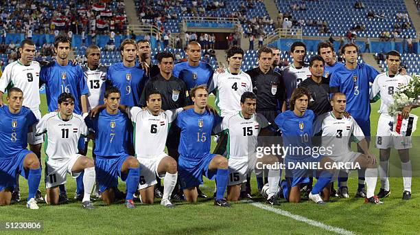 Italian and Iraqi players posse together for the photographers before the bronze medal men's soccer match at Thessaloniki stadium 27 August 2004 for...