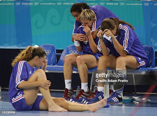 French players show their dejection after losing the women's handball bronze medal match against the Ukraine on August 28, 2004 during the Athens...