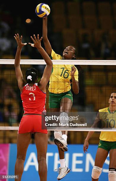 Fabiana Claudino of Brazil spikes the ball against Nancy Carrillo de la Paz of Cuba in the women's indoor Volleyball bronze medal match on August 28,...