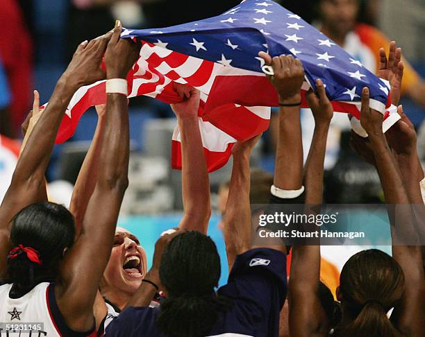 The United States team celebrate winning the gold medal in the women's basketball gold medal match between United States of America and Australia on...