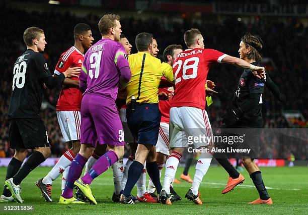 Players try to separate Marco Urena of FC Midtjylland and Jesse Lingard of Manchester United during the UEFA Europa League Round of 32 second leg...
