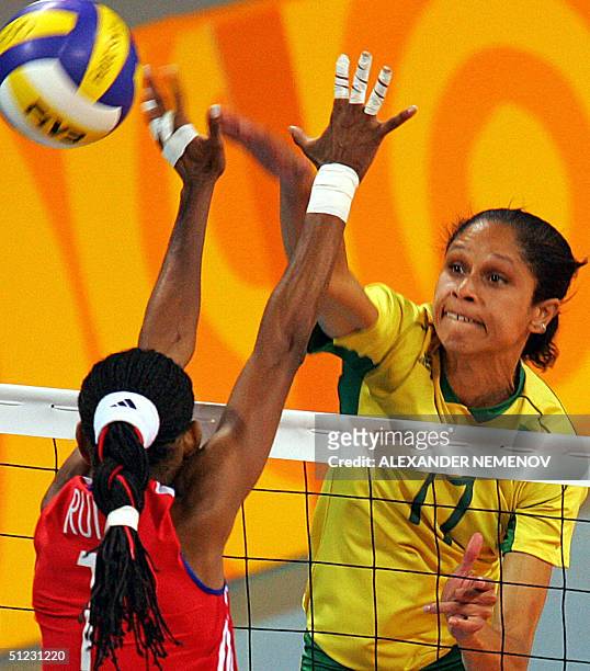 Brazilian captain Fernanda Venturini smashes the ball against Cuban captain Yumilka Ruiz Luaces during the bronze medal volleyball match between...