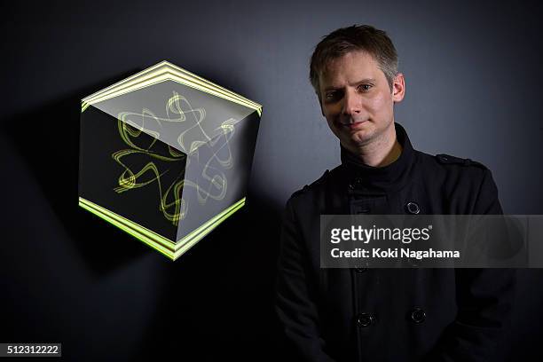 Alex Augier poses a photograph in front of his artwork "vVvoxel" during the Media Ambition Tokyo 2016 at VENUE on February 25, 2016 in Tokyo, Japan....
