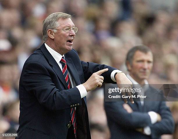 Sir Alex Ferguson, the Manchester United manager, tells the referee to check his watch during the FA Barclays Premiership match between Blackburn...