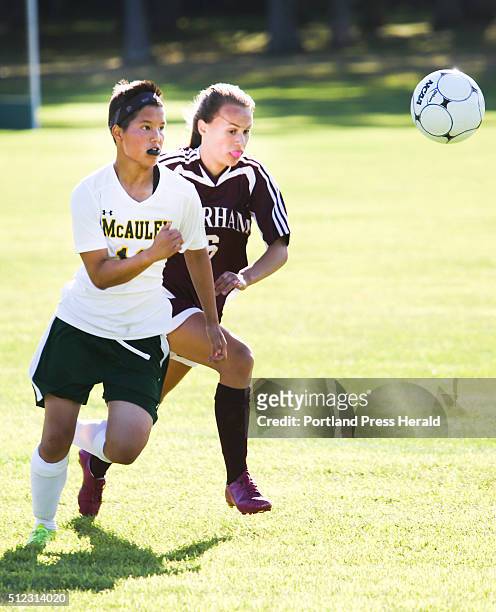 Catherine McAuley defender Kim Fisher and Gorham player Alexis Fotter chase the ball at Catherine McAuley high school in Portland, ME on Friday,...