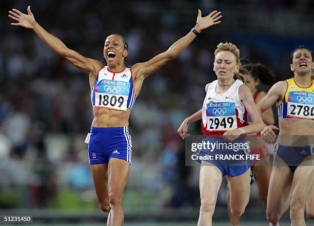 Britain's Kelly Holmes crosses the finish line first for the gold, ahead of Russia's Tayana Tomashova , who took silver and Romania's Maria Cioncan ,...