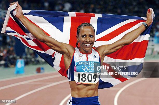 Britain's Keylly Holmes celebrates with her country's flag after winning the gold in the women's 1,500m final ahead of Russia's Tatyana Tomashova at...