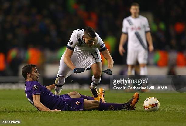 Milan Badelj of Fiorentina pulls on the shorts of Erik Lamela of Tottenham Hotspur as he makes a tackle during the UEFA Europa League match between...