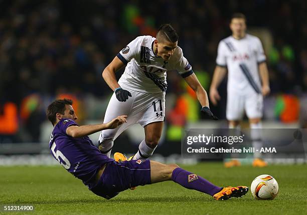 Milan Badelj of Fiorentina pulls on the shorts of Erik Lamela of Tottenham Hotspur as he makes a tackle during the UEFA Europa League match between...