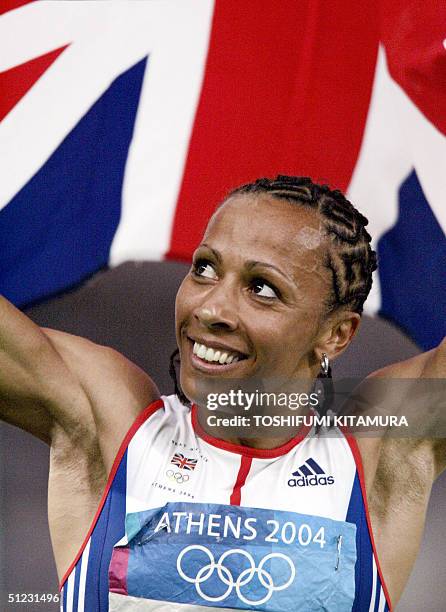 Britain's Kelly Holmes takes a victory lap after she won gold in the women's 1500m final, 28 August 2004, during the Olympic Games athletics...