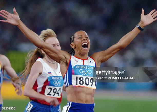 Britain's Kelly Holmes reacts after winning the women's 1,500m final ahead of Russia's Tatyana Tomashova at the Olympic Stadium 28 August 2004 during...