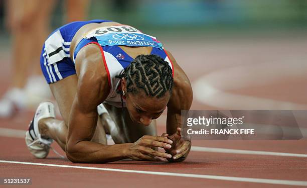 Britain's Kelly Holmes reacts after winning the women's 1,500m final at the Olympic Stadium 28 August 2004 during the Olympic Games athletics...