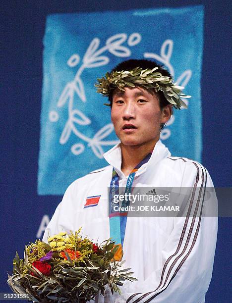 Silver medalist Song Guk Kim of North Korea stands on the podium during the awards ceremony of the Olympic Games featherweight boxing competition 28...