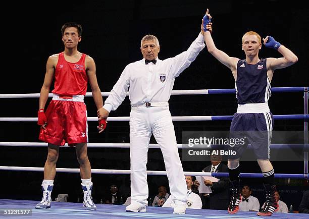 Alexei Tichtchenko of Russia celebrates his win over Song Guk Kim of DPR Korea after the men's boxing 57 kg final bout on August 28, 2004 during the...