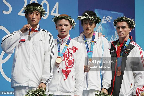 Song Guk Kim , Alexei Tichtchenko , Seok Hwan Jo and Vitali Tajbert receive their medals during ceremonies for the men's boxing 57 kg class on August...