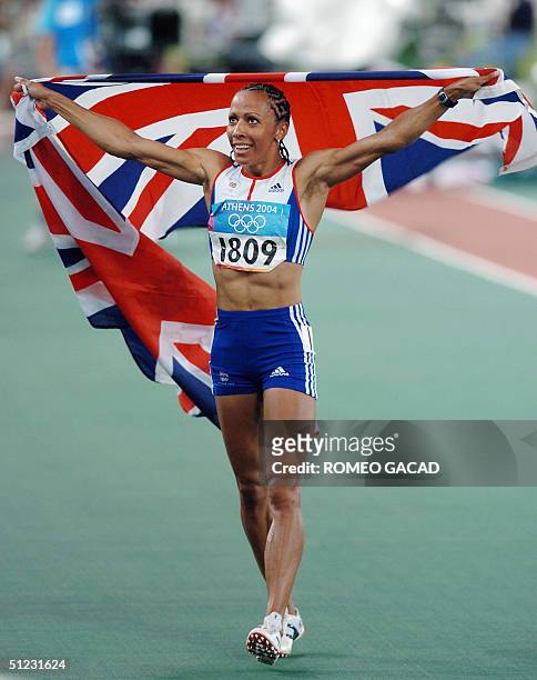 Britain's Kelly Holmes celebrates with her country's flag after winning the gold medal of the women's 1,500m final at the Olympic Stadium 28 August...