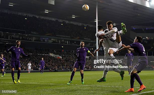 Dele Alli and Nacer Chadli of Tottenham compete for the same ball in the air during the UEFA Europa League Round of 32 second leg match between...