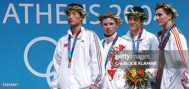 Medalists in the Olympic Games featherweight boxing competition stand on the podium during the awards ceremony at the Peristeri Boxing Hall 28 August...