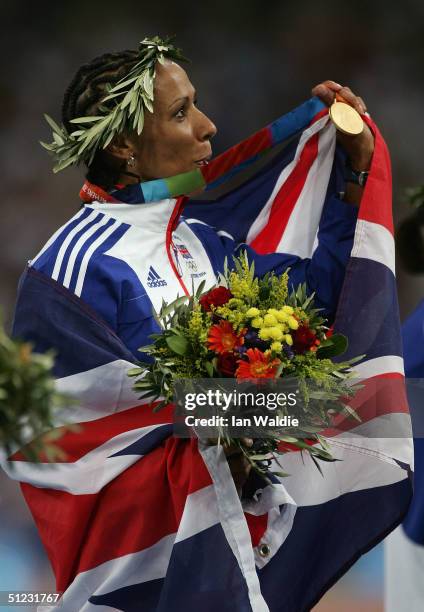 Gold medalist Kelly Holmes of Great Britain celebrates on the podium during the medal ceremony of the women's 1,500 metre event on August 28, 2004...