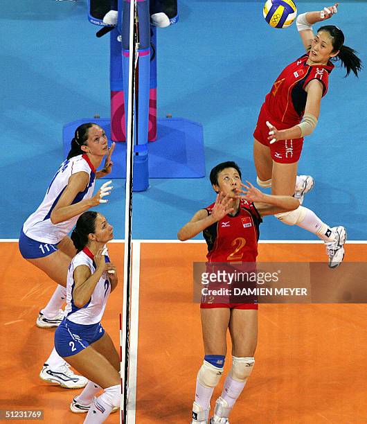 Chinese captain Feng Kun sets the ball to her teammate Yang Hao as their Russian opponents Russian Ekaterina Gamova and Irina Tebenikhina get ready...
