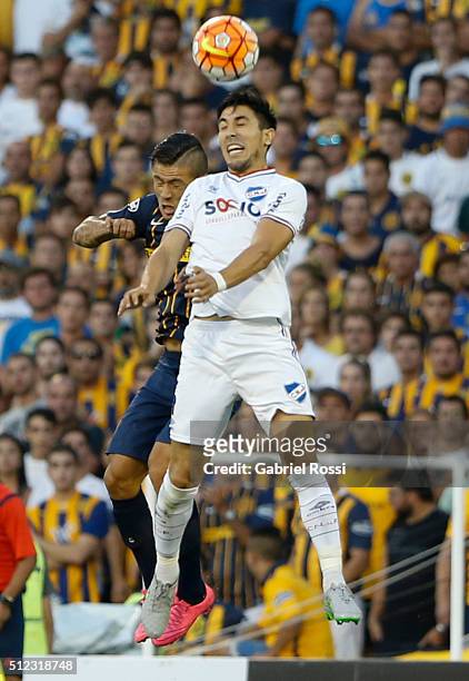 Mauricio Victorino of Nacional fights for the ball with Pablo Becker of Rosario Central during a group stage match between Rosario Central and...