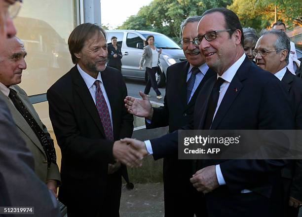 French President Francois Hollande shakes hands with the Director of the Pasteur Institute, Luis Barbeito, next to the President of the Board of...