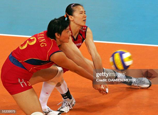 Chinese Yang Hao and her teammate Zhou Suhong receive the ball during the gold medal volleyball match between Russia and China at the Olympic Games,...