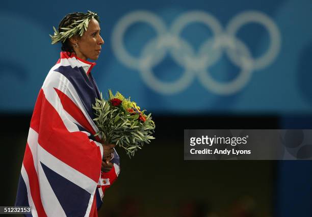 Gold medalist Kelly Holmes of Great Britain celebrates on the podium during the medal ceremony of the women's 1,500 metre event on August 28, 2004...