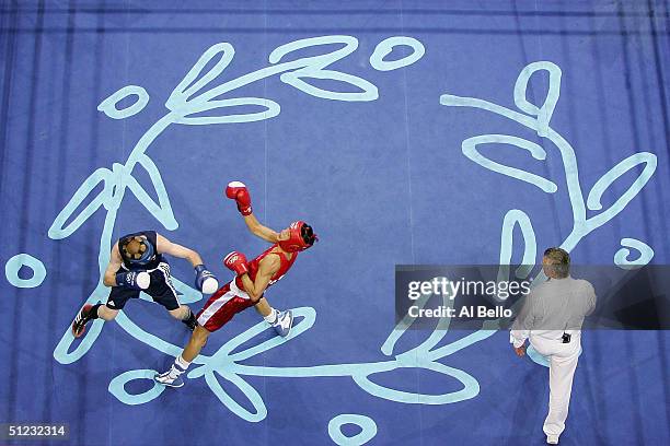 Song Guk Kim of DPR Korea and Alexei Tichtchenko of Russia compete during the men's boxing 57 kg final bout on August 28, 2004 during the Athens 2004...