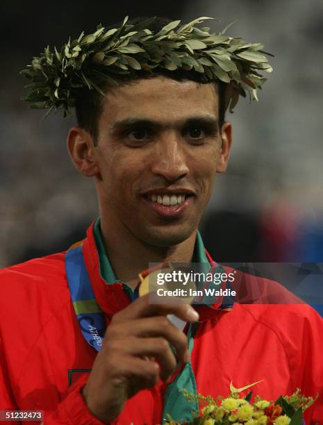 Gold medalist Hicham El Guerrouj of Morocco celebrates on the podium during the medal ceremony of the men's 5,000 metre medal ceremony on August 28,...