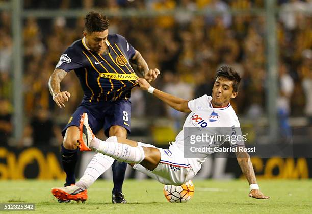 Pablo Alvarez of Rosario Central fights for the ball with Kevin Ramirez of Nacional during a group stage match between Rosario Central and Nacional...
